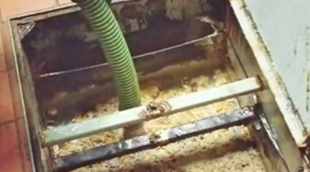 Clean grease traps for Indiana Kitchen Fire Suppression and other reasons image shows dirty grease trap